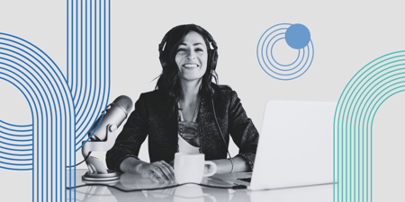 Professional woman at desk wearing headphones and broadcasting into microphone