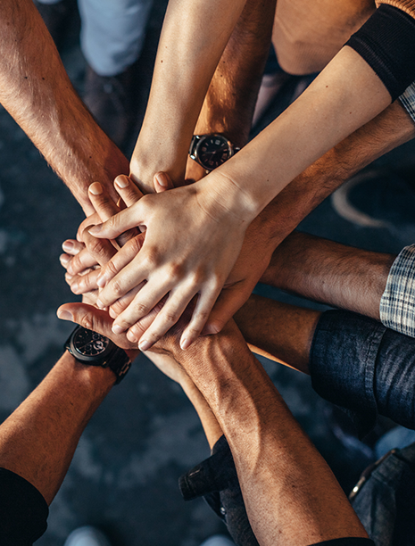 Hands overlapping in a team huddle