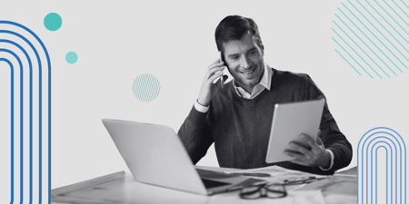Man holding phone at desk