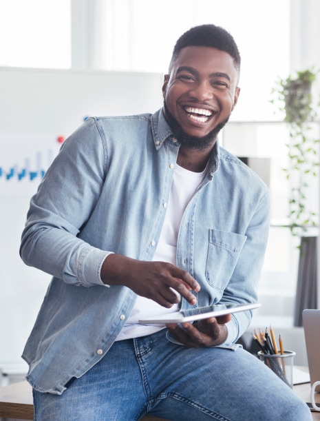 man smiling with tablet in hand