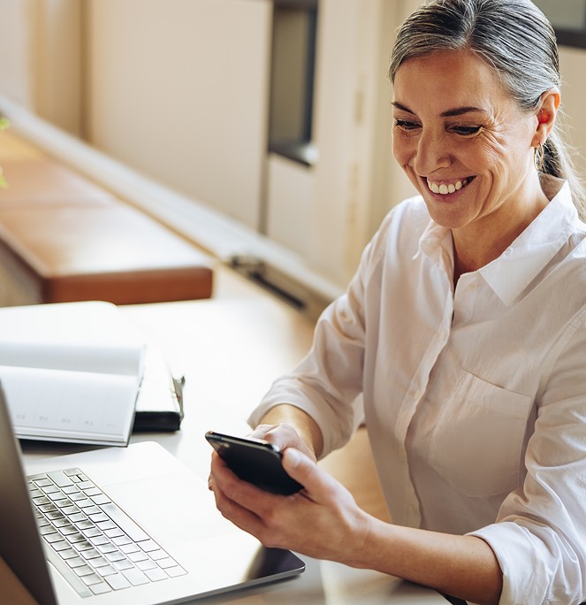 woman smiling at phone