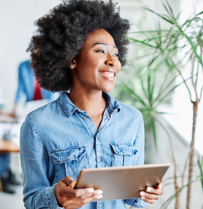 woman smiling holding tablet