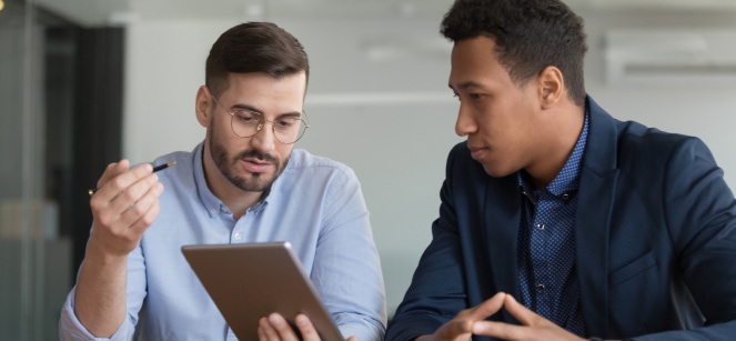 two workers looking at tablet