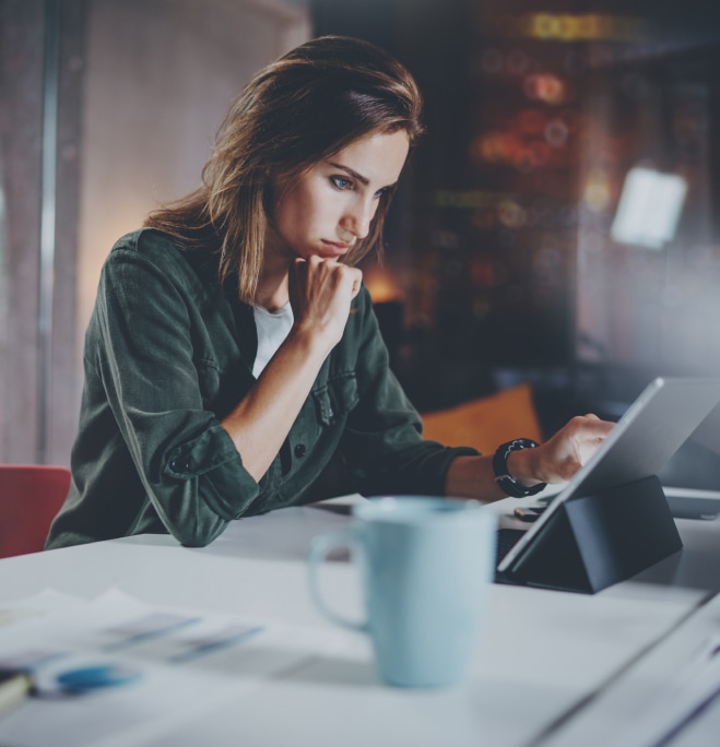 woman looking at tablet