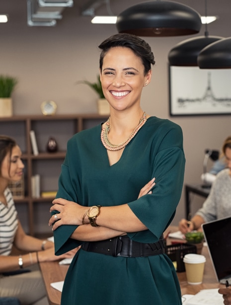 Smiling professional using association management software in office environment