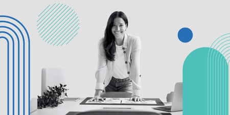 Woman leaning over the desk with a marketing plan under her hands