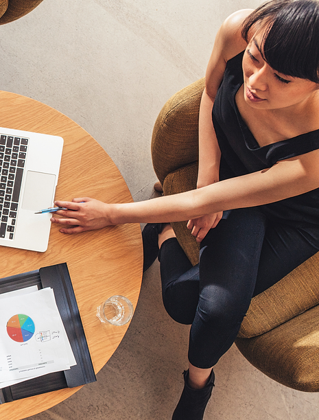 Woman at table looking at graphs