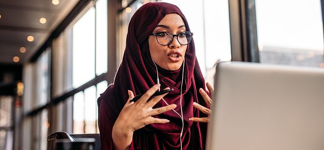 woman in a meeting on her computer