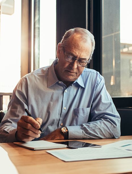 Man at table with notepad