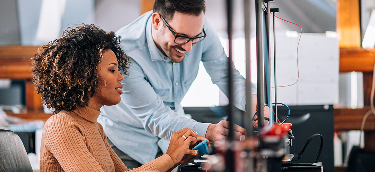 Colleagues working together on a 3D printer