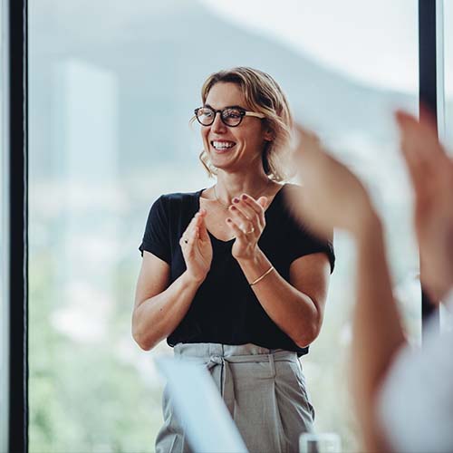 woman smiling and clapping